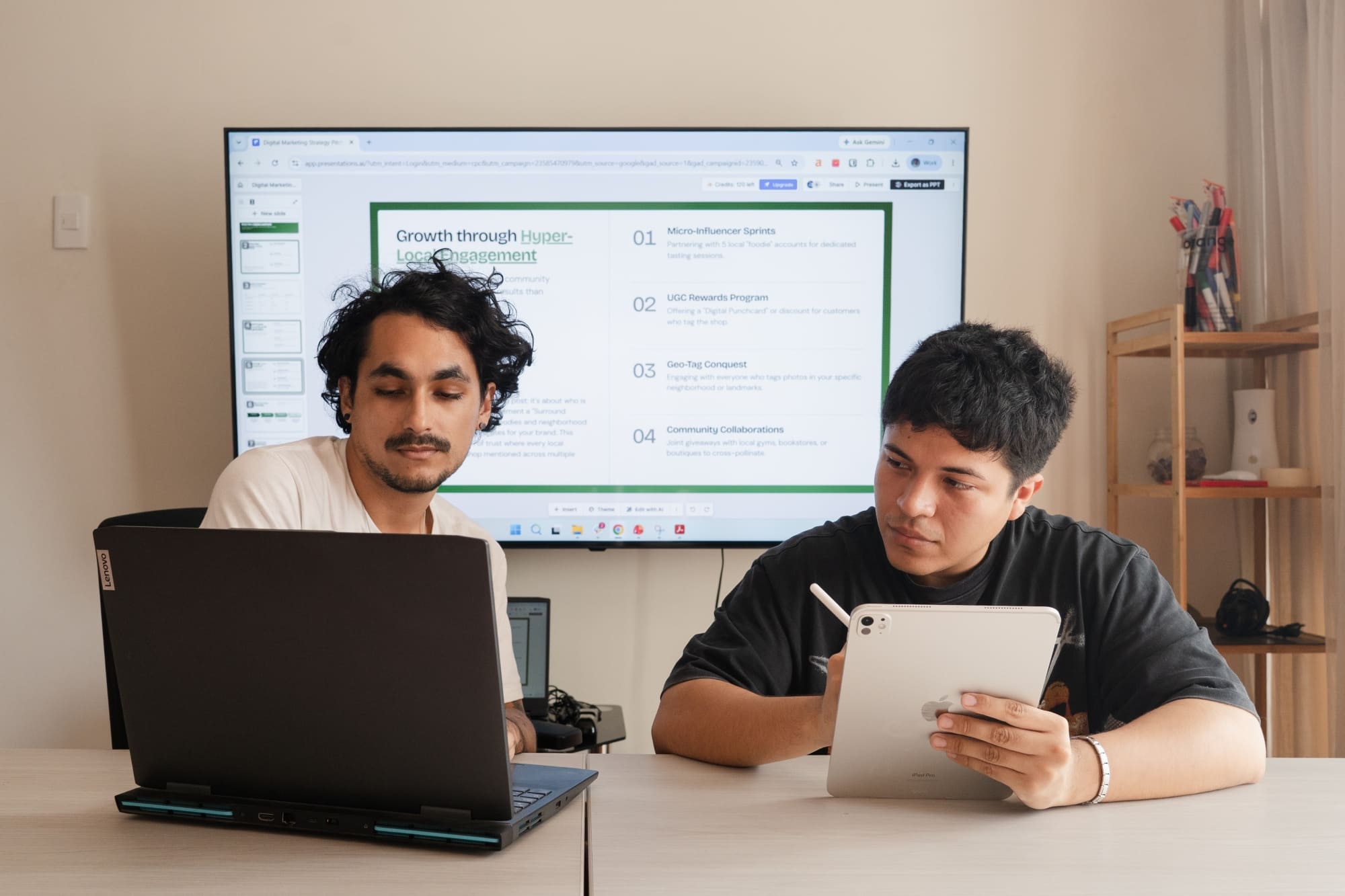 24Slides marketing designers Gabo and Leo actively evaluating and taking notes on a Presentations.ai slide draft during an agency stress test.