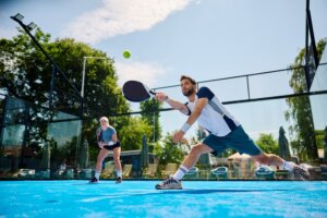 Young,Athlete,Playing,Padel,In,Mixed,Doubles,On,Outdoor,Court.