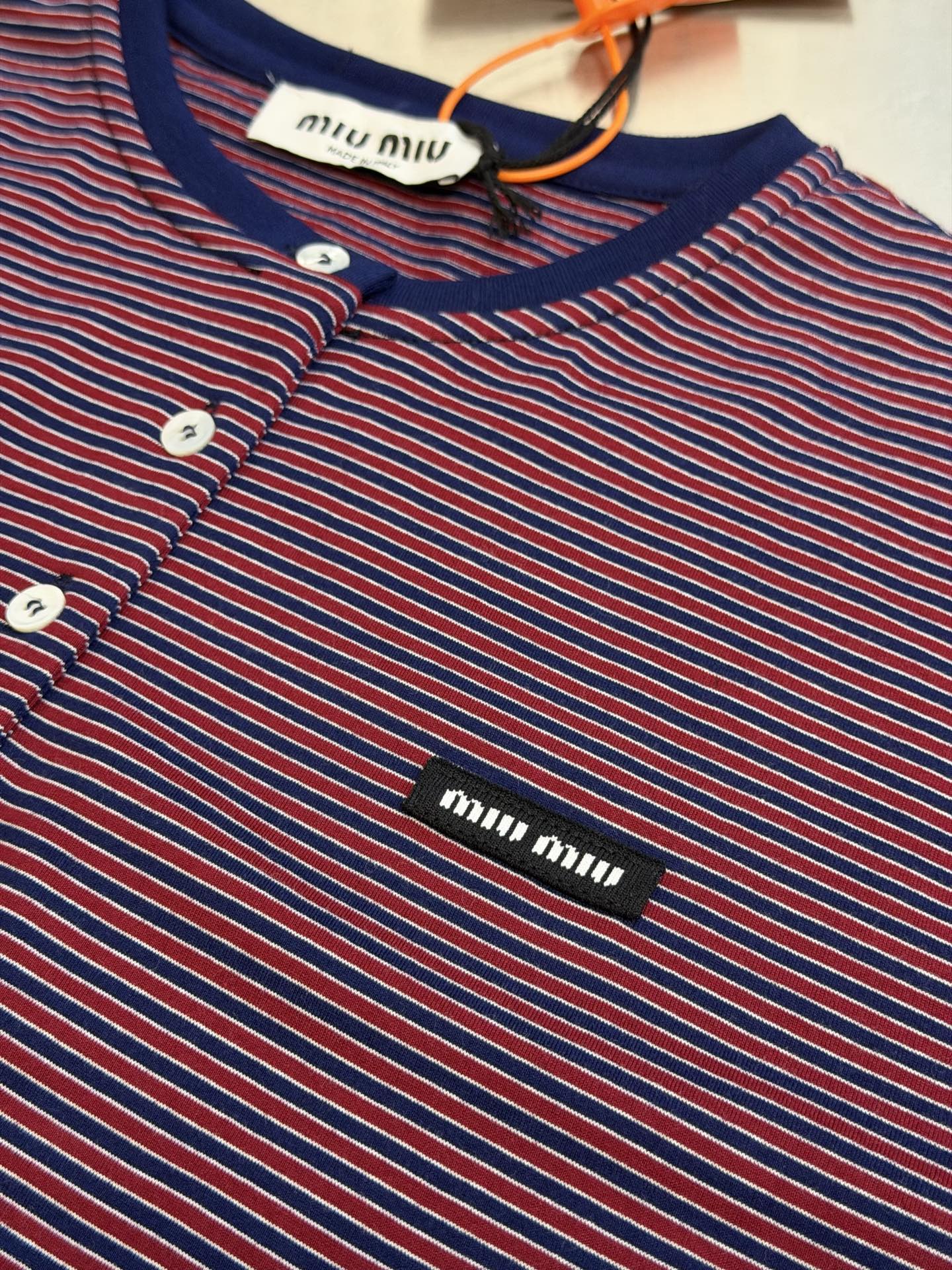 Miu logo striped henley collar long sleeves Customized textured plain weave cotton, intertwined green and burgundy thin strips of warp and weft, layered colors, classic henley half placket configuration, neat opening and closing, contrasting collar edge delicately outlines the collar, brand woven logo sewn on the left chest, loose dropped shoulders silhouette, integrating the Italian retro college heritage into the daily shape, interpreting a relaxed and elegant high-end elegance style - Image 7