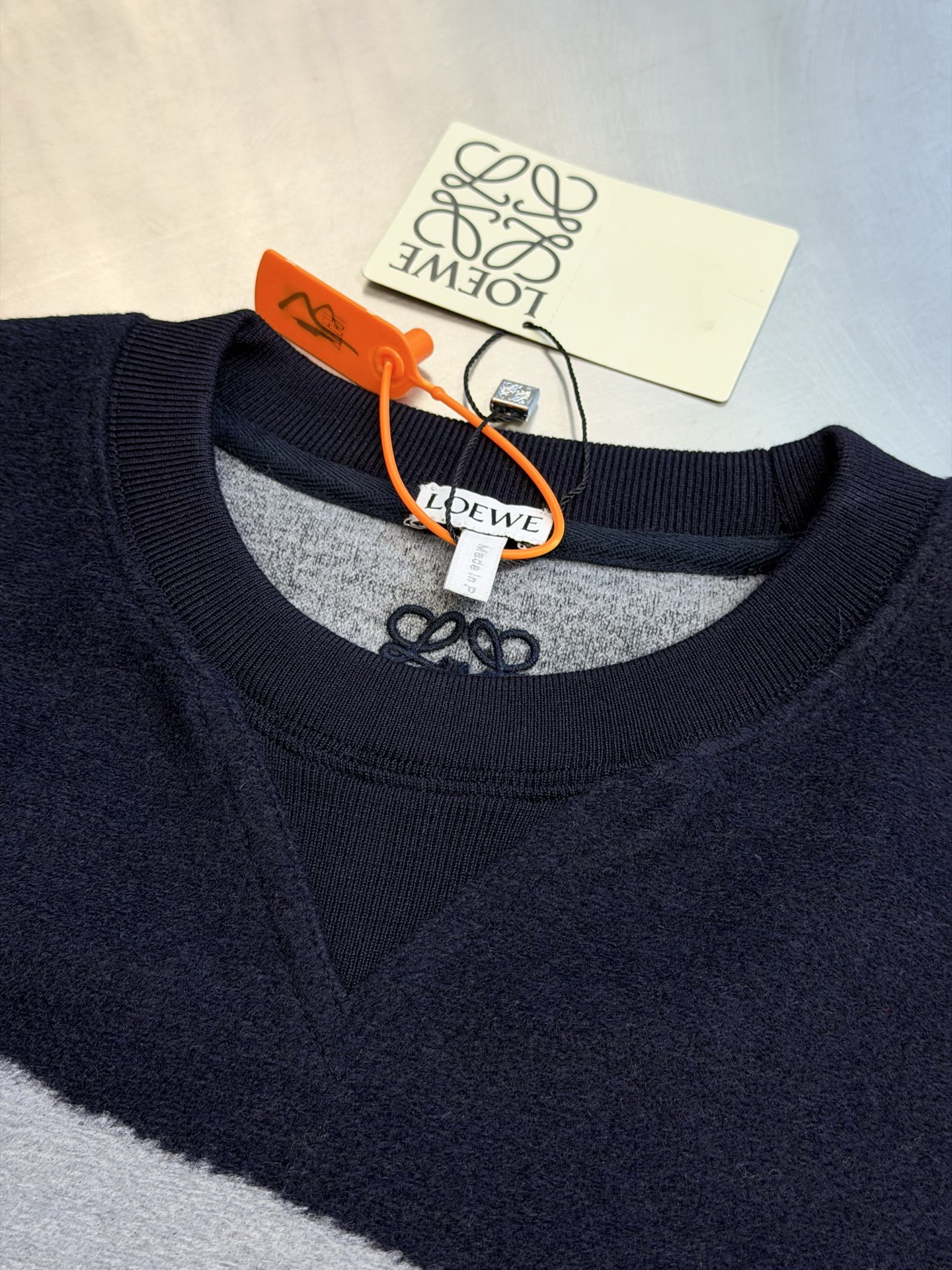 Lew Anagram embroidered jacquard sweater Custom-woven cotton blend with sequence pattern, two-color warp and weft intertwined, abstract streamlined large curve pattern spread vertically and horizontally, stretched Anagram symbol wanders freely, a small Anagram embroidery is placed in the center of the back of the neck, the stitching is even and concise, accurately annotating the brand's collection of aesthetic symbols - Image 6