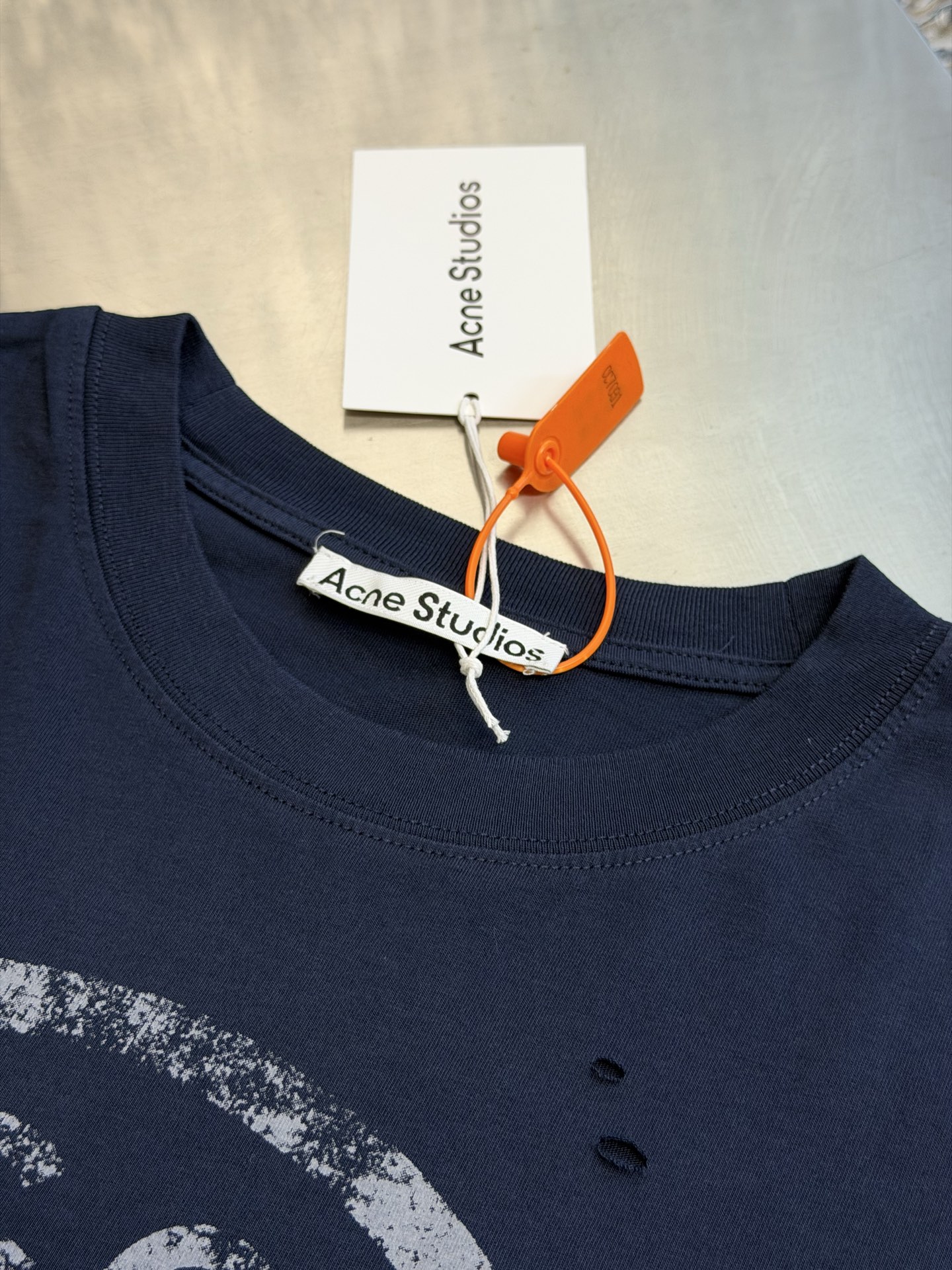 Ac Studios Distressed Logo Fake Two Piece Long Sleeve Customized plain cotton with weft sequence, neat round neck, simple and restrained, layered structure cleverly creates fake two-piece layers, short sleeves stacked on long sleeves for a three-dimensional look, the chest is embellished with the seasonal denim-style rivet logo, retro marks are dimly deposited on the fabric, the body is staggered with frayed holes, and the natural texture of the fabric is deconstructed, and the loose shoulder silhouette is relaxed. - Image 5