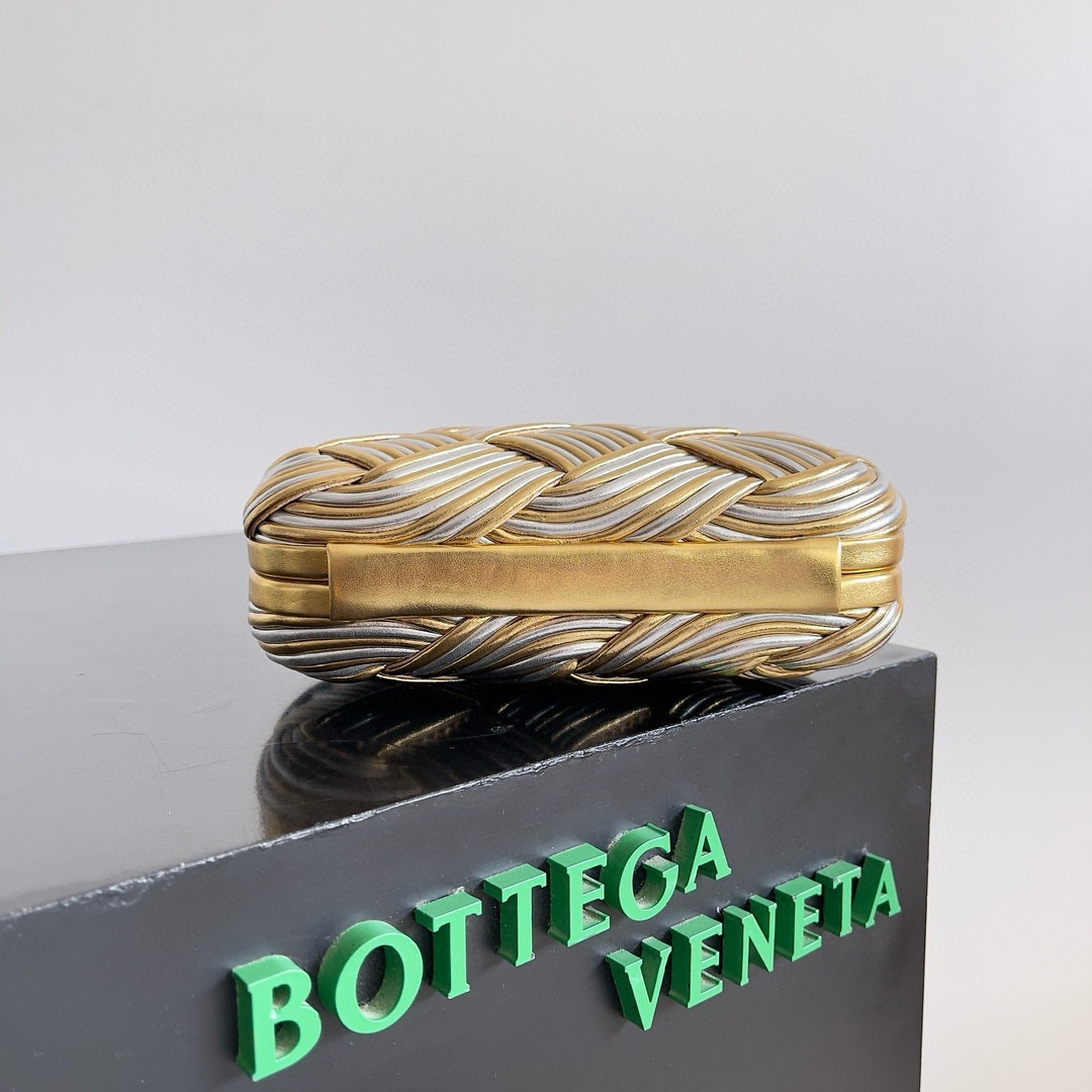 B.V. π Knot Evening Clutch This clutch is crafted from interwoven strips of gold and silver two-tone leather, paired with the iconic Knot metal twist detail and structured frame design. - Image 4