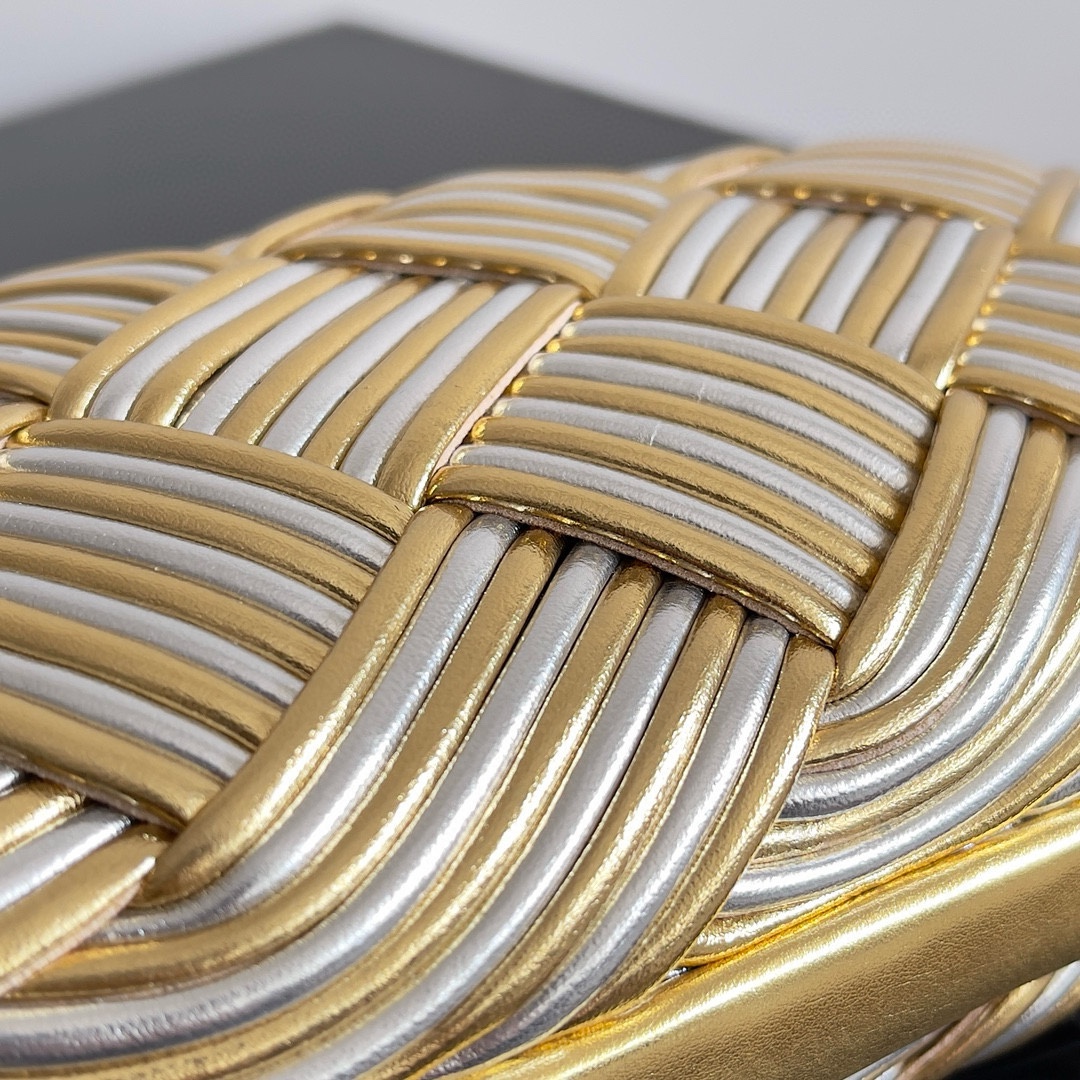 B.V. π Knot Evening Clutch This clutch is crafted from interwoven strips of gold and silver two-tone leather, paired with the iconic Knot metal twist detail and structured frame design. - Image 7