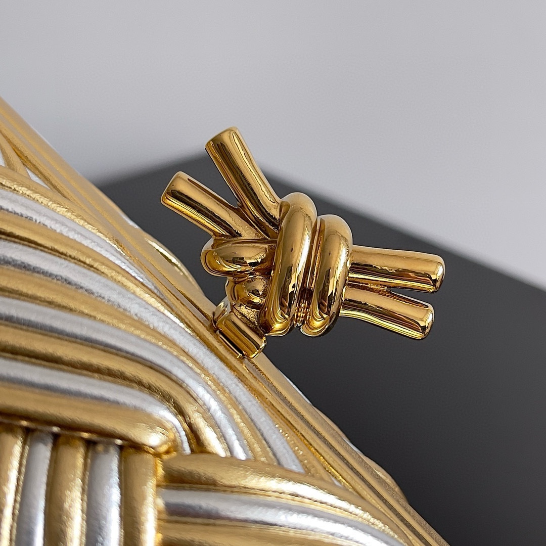 B.V. π Knot Evening Clutch This clutch is crafted from interwoven strips of gold and silver two-tone leather, paired with the iconic Knot metal twist detail and structured frame design. - Image 8