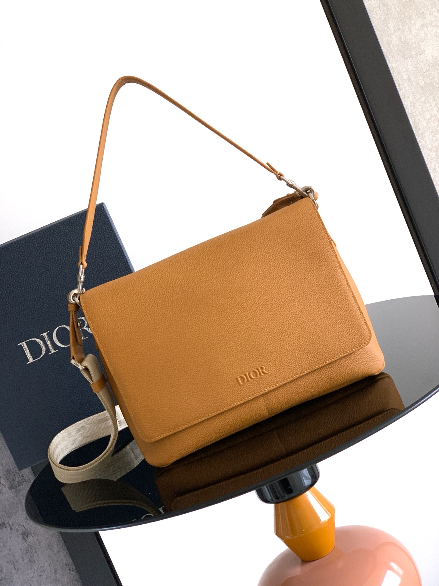 Sophisticated and elegant, this Dior Privé flap messenger bag
