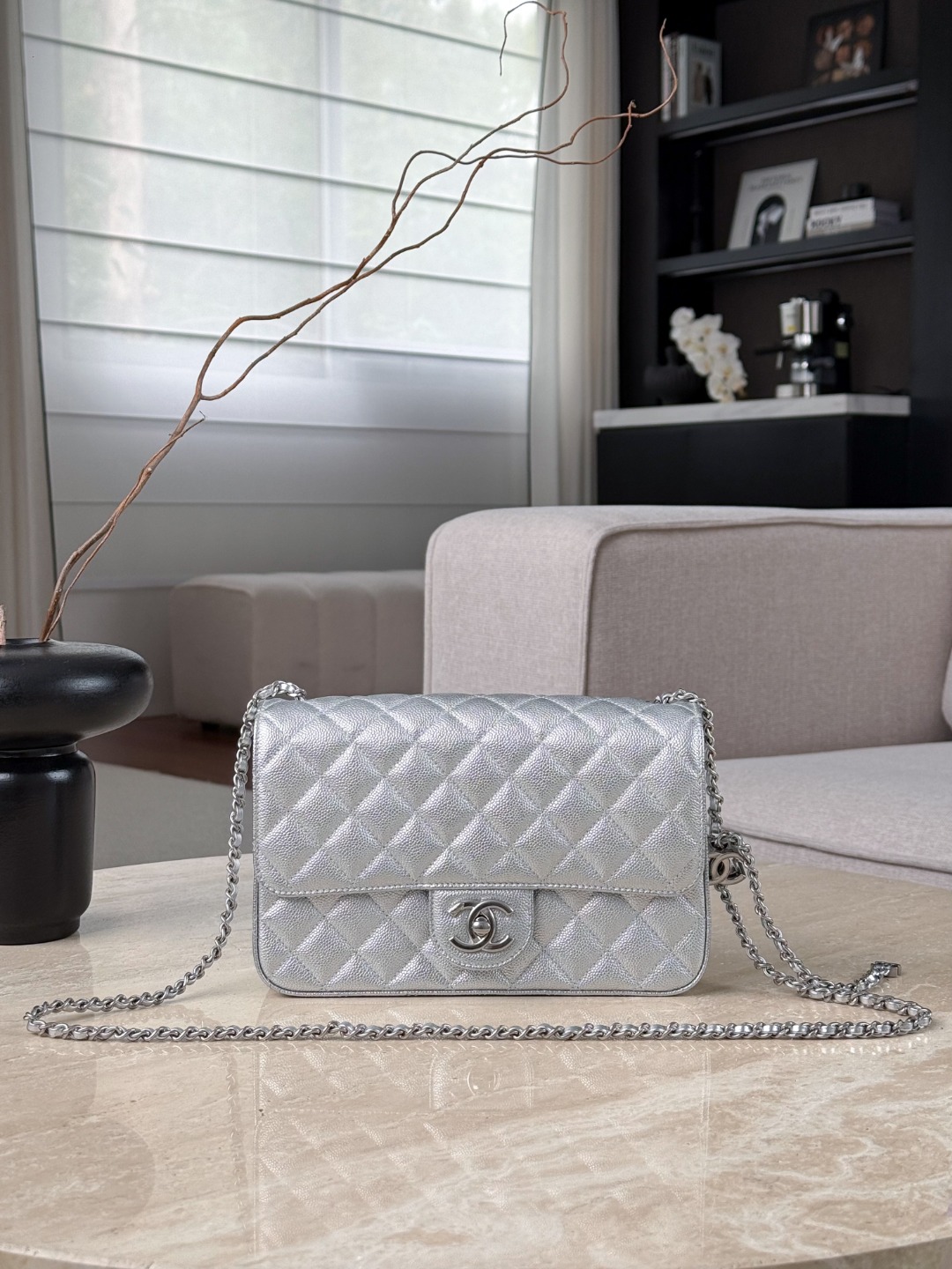 The silver metal chain and double C buckle give it a futuristic feel