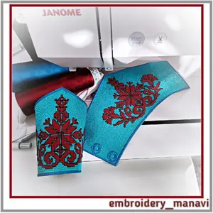 Close-up of the curve of a turquoise embroidered cuff bracelet showing a snap closure and textured red stitching by Embroidery Manavi 05.