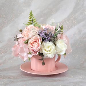 Handmade Marketplace 670 Artificial flower arrangement in a pink teacup.