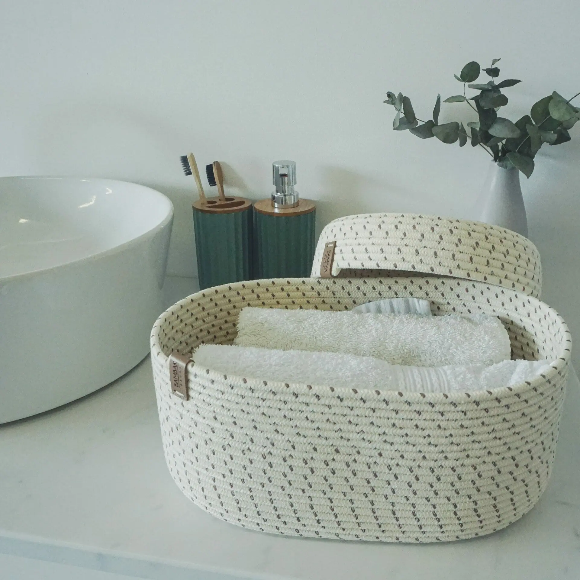oval white rope basket with lid in bathroom.jpg
