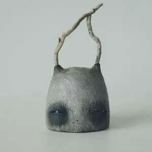art sculpture stone head with branches close view