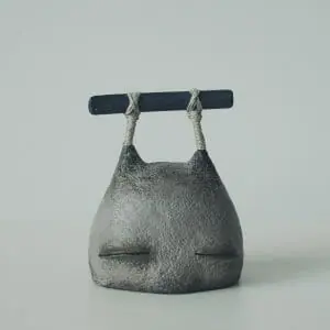 art sculpture stone head with rock close view