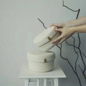 set of two white rope baskets with lid in hand