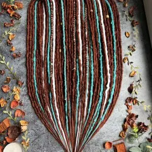 Ginger and teal dreads with white accents, bumpy ginger dreadlocks