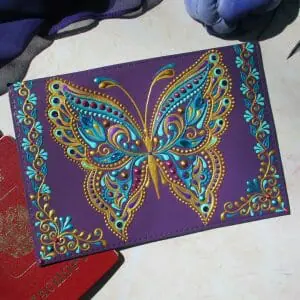 Hand painted leather passport holder with butterfly.