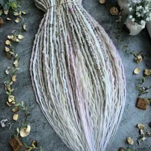 Light gray and pink dreads, cold blonde dreads and curls