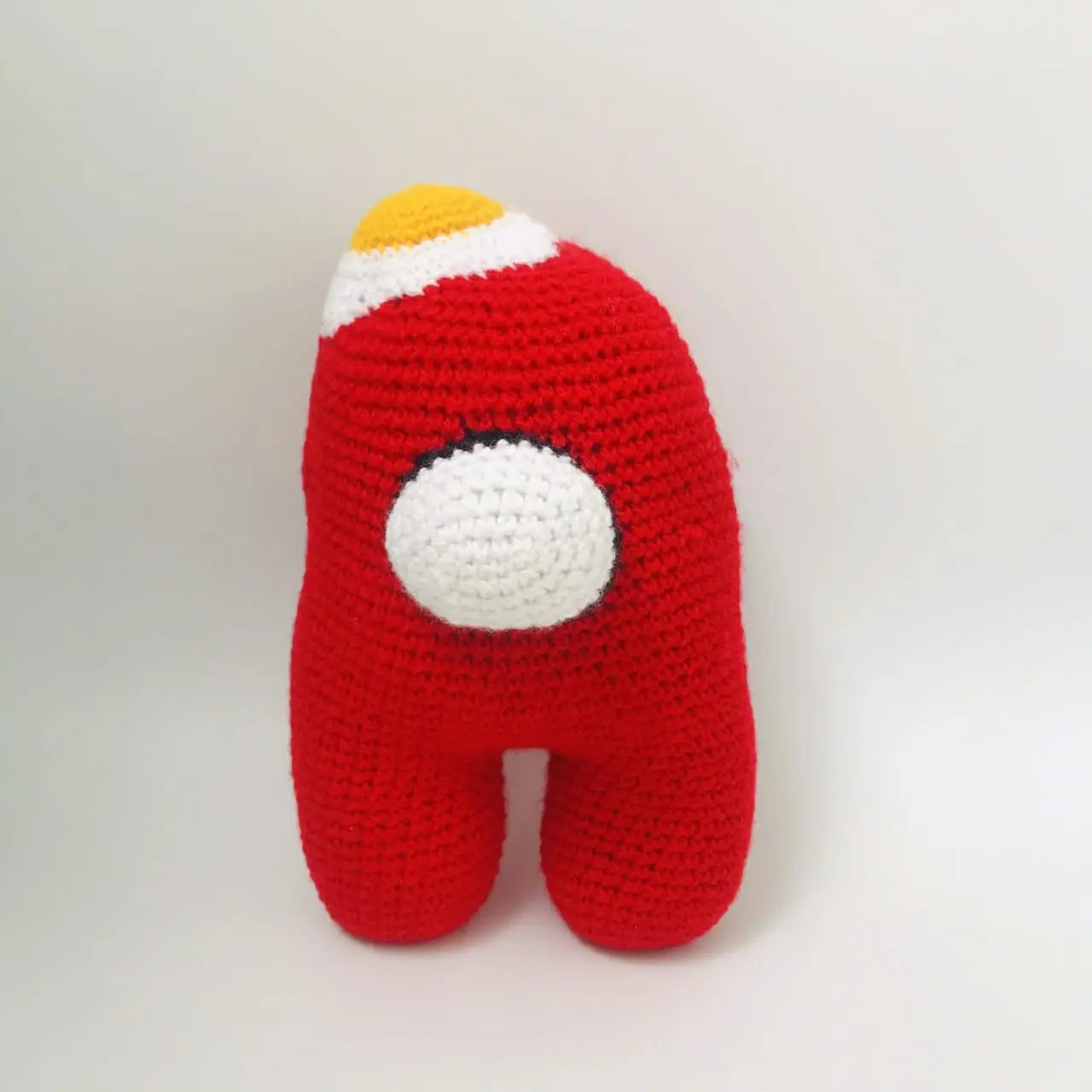 Knitted decorative toy “Red Cosmonaut”