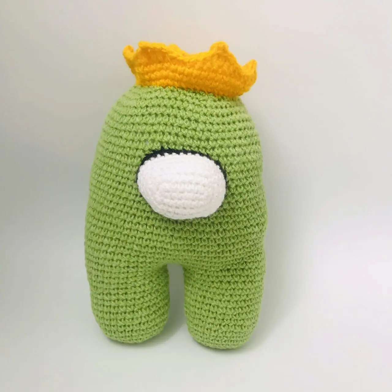 Knitted decorative toy “Green Cosmonaut”