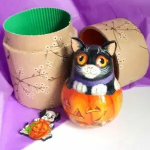 characters of the Halloween holiday.Naughty black cat on a pumpkin.