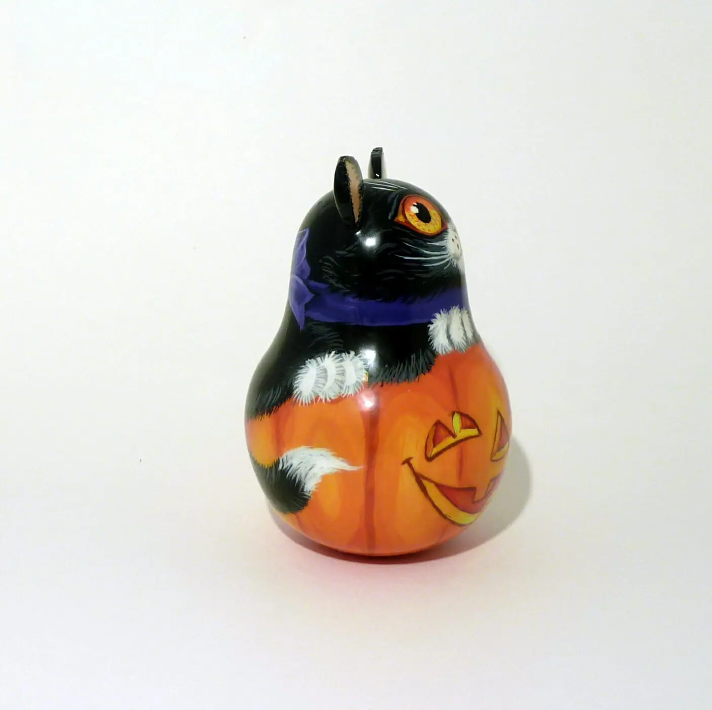 a small decorative pumpkin and a black cat . an unusual bell for halloween . wooden tinkling roly poly doll hand painted 5.jpg