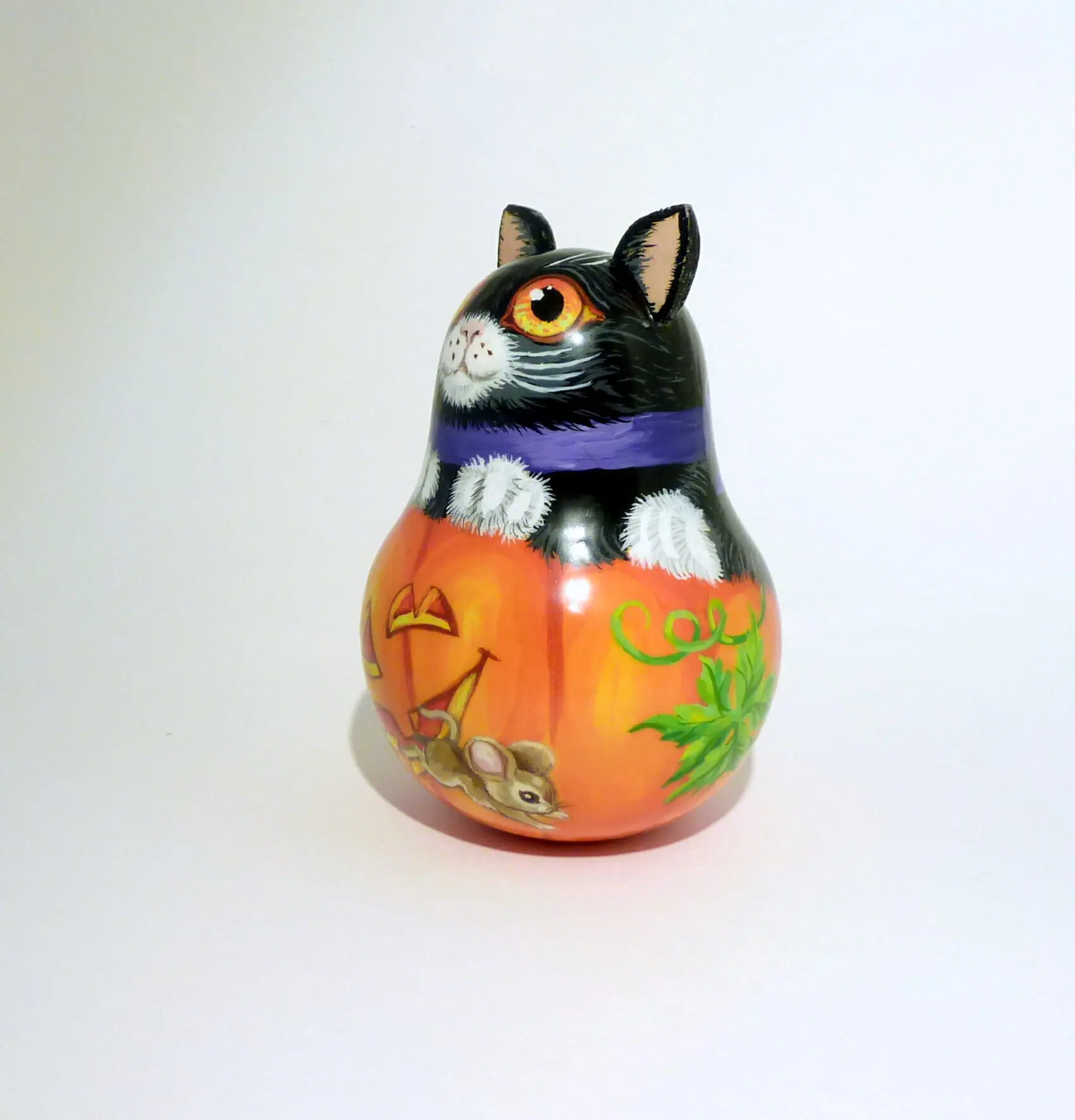 a small decorative pumpkin and a black cat . an unusual bell for halloween . wooden tinkling roly poly doll hand painted 8.jpg