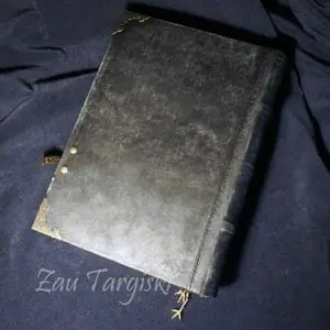 Black book of shadows, magic diary with a crow and a black stone