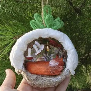 Christmas tree toy squirrel in a hollow made of cotton wool