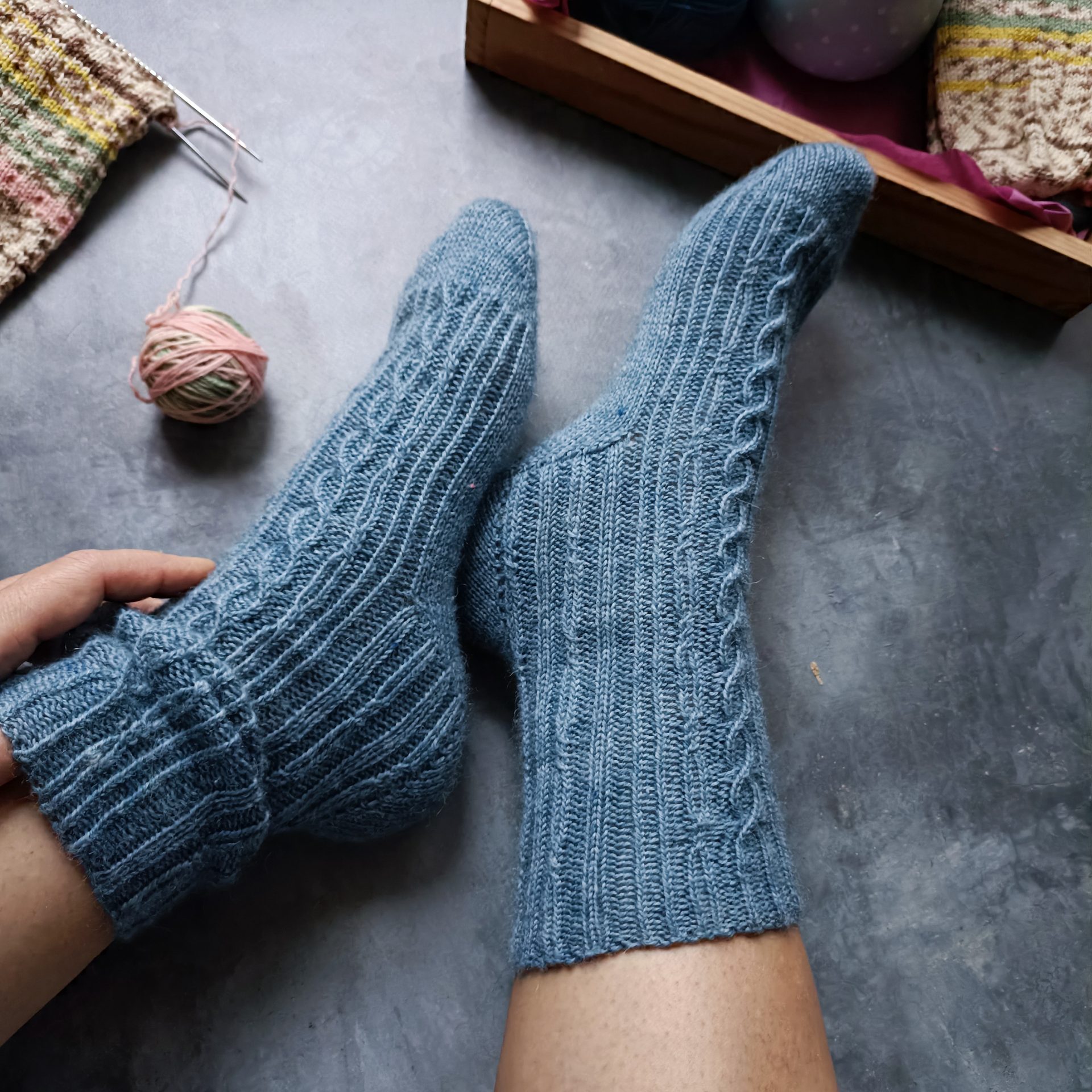 A pair of handmade blue knitted wool socks