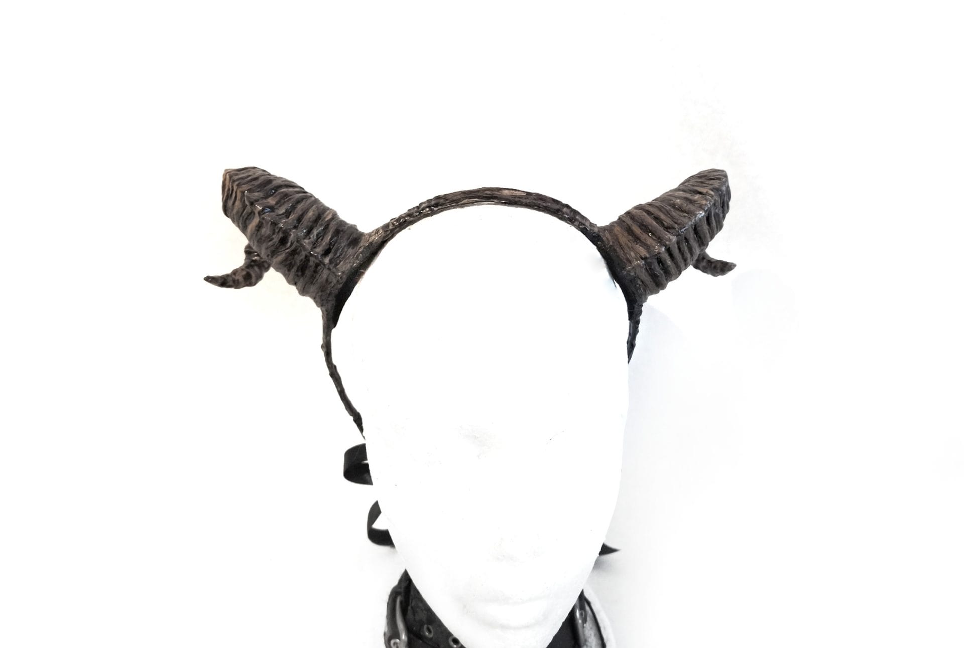 Small twisted ram horns on the headband