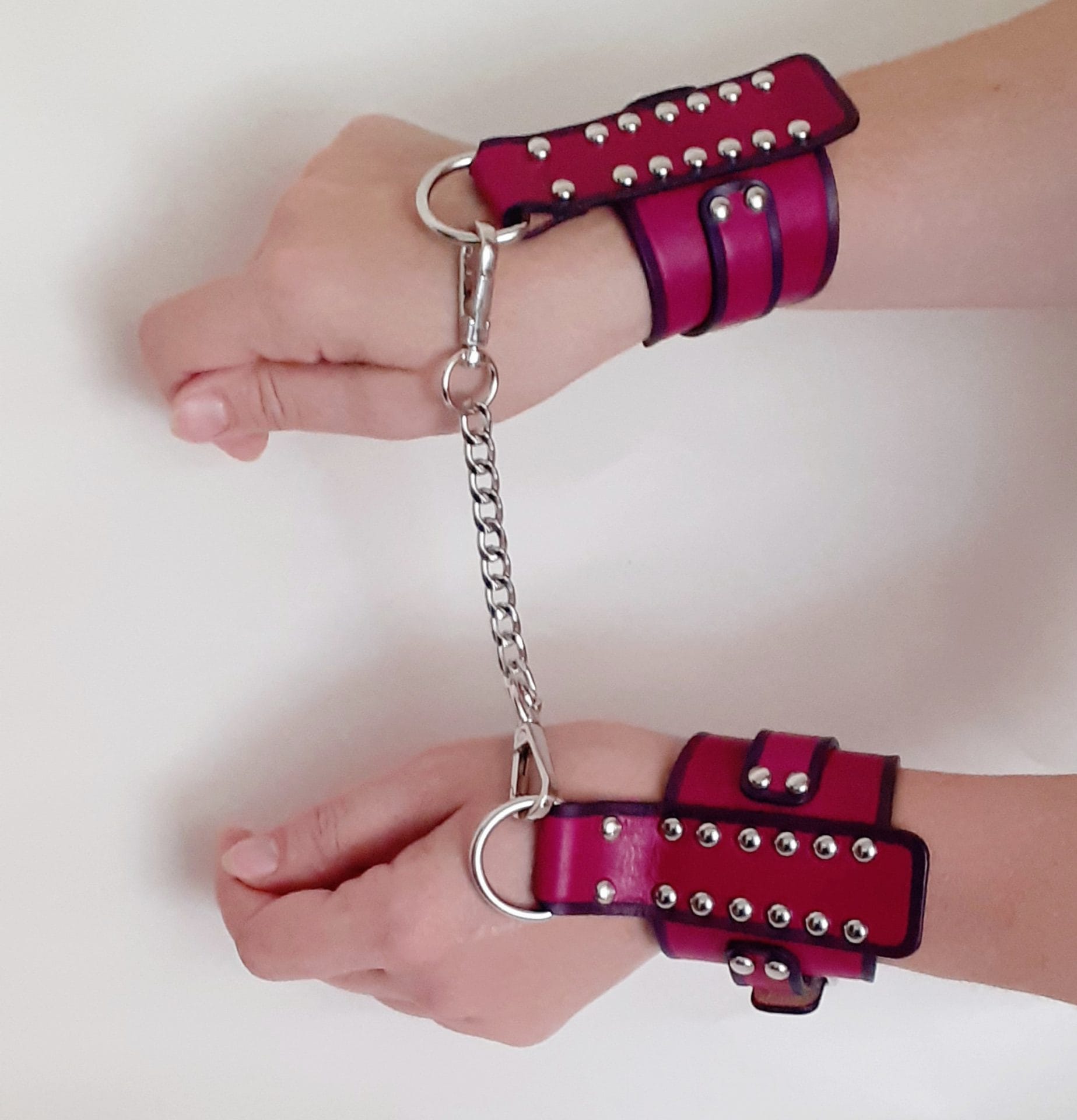 Personalized wide womens bdsm handcuffs made of fuchsia leather