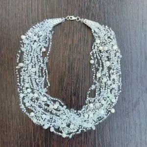 A white small delicate airy layered necklace made of beads and pearl