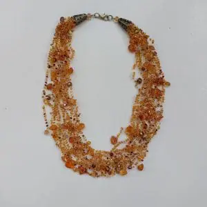 A small delicate airy layered necklace made of beads with amber.