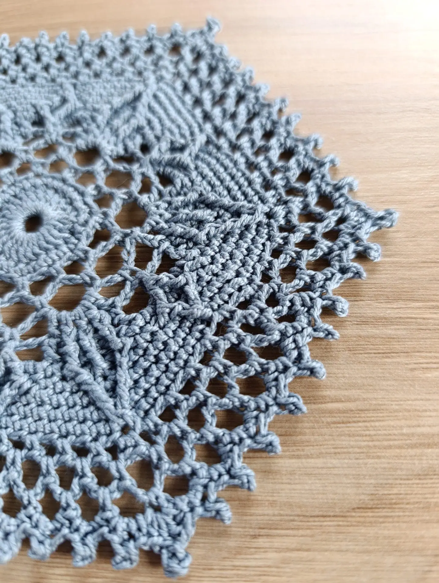 Textured relief doily of cotton steel (grey) color