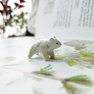 Cute ceramic polar bear figurine with floral ornament