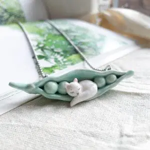whimsical ceramic cat sleeping in pea pod necklace