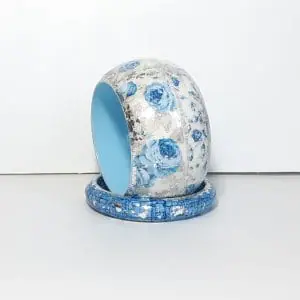 Stylish set of 2 bracelets. They are made of wood but look like porcelain . Blue roses on a white background with silver enamel .