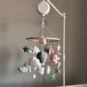 Handmade felt baby mobile with gray, pink, and green bunnies, fluffy clouds, and a large hot air balloon. Soft pastel nursery decor, safe for newborns, gender-neutral crib mobile