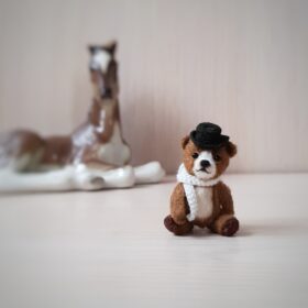 Miniature teddy bear in a hat