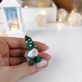 Green toy gnome miniature crochet in hand