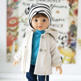 Doll boy Paola Reina Los Amigas in a white jacket, blue jeans and boots.