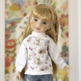 A 14-inch Ruby Red Fashion Friends doll in handmade Easter sweatshirt with a print of Easter bunnies and eggs.