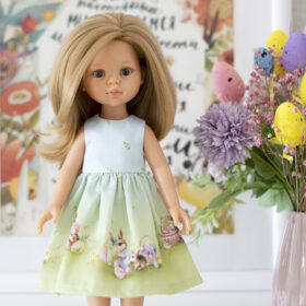 A13 inch Paola Reina doll in a blue-green dress with a print of Easter bunnies and eggs for Easter