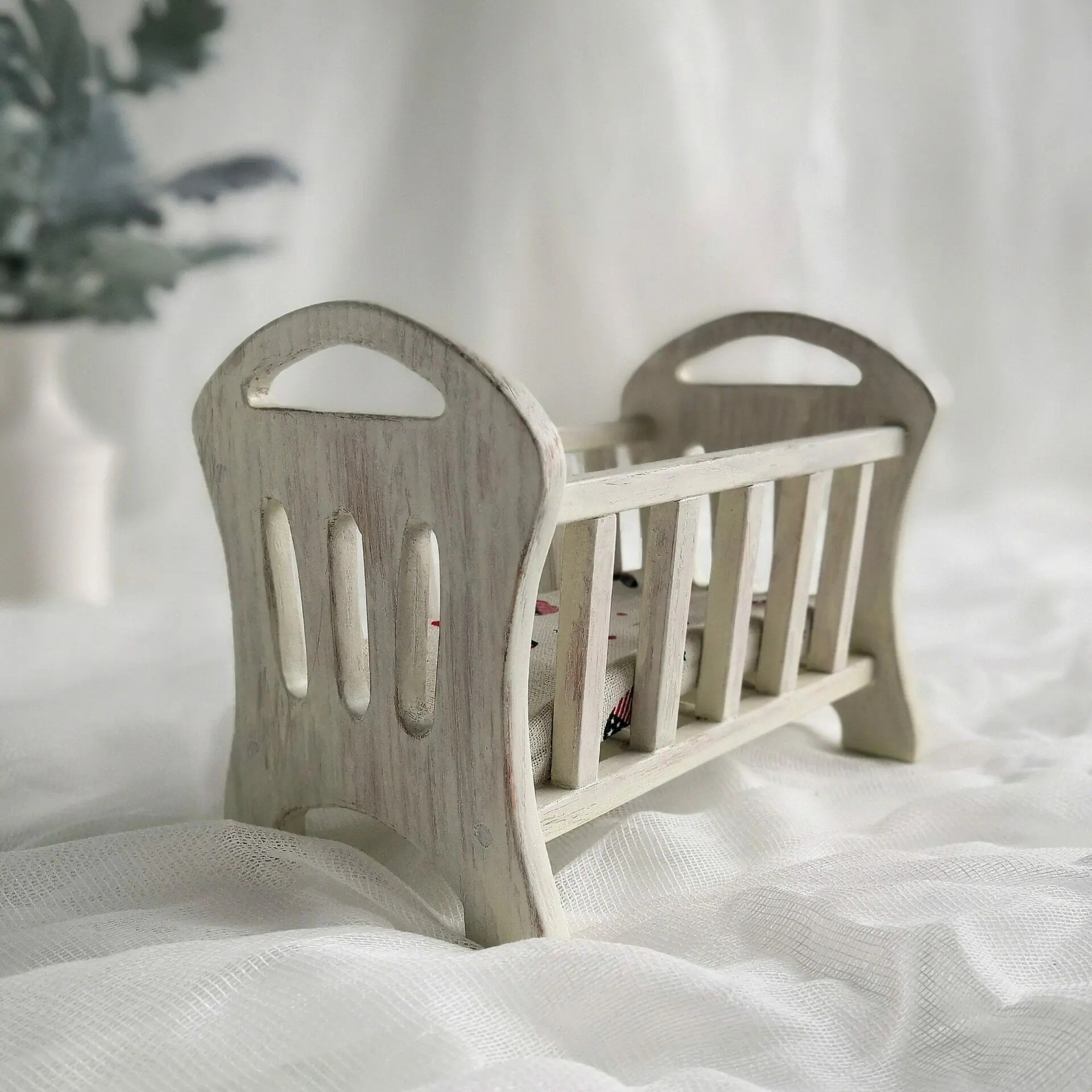 White wooden doll top crib