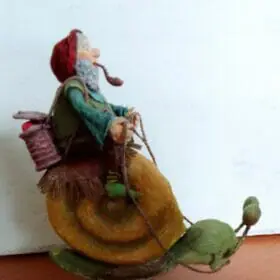 Bearded gnome rides on a snail