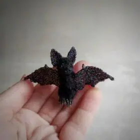 miniature bat with shiny wings