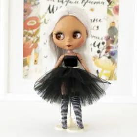 Blythe doll in black outfit and striped stockings