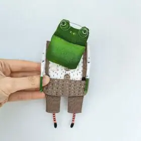 one-of-a-kind-textile-art-doll-frog-boy-in-gray-pants-in-hand