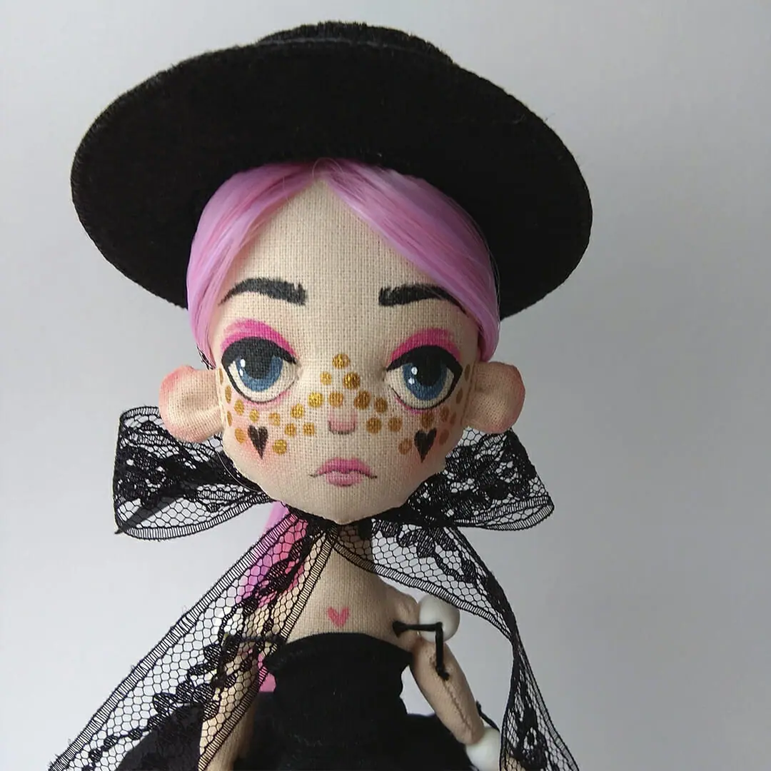 Doll with pink hair, tattoo and little black dress