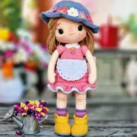 Little gardener doll in a pink dress