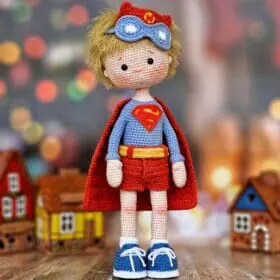 Superhero doll boy in a red cape