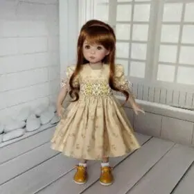 Effner 13 inch Little Darling yellow smocked dress with hand embroidery.